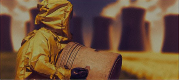 Man in yellow HazMat suit carrying a cylinder